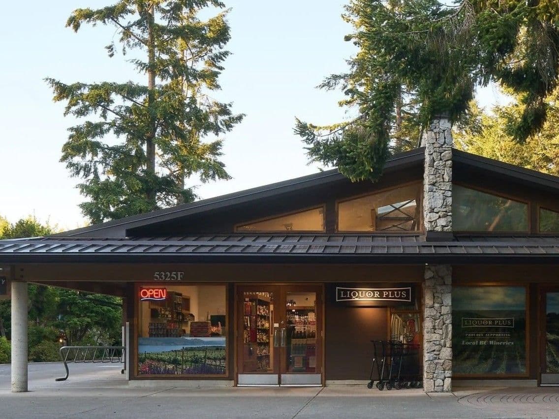 International wine aisle under a skylight with country signs