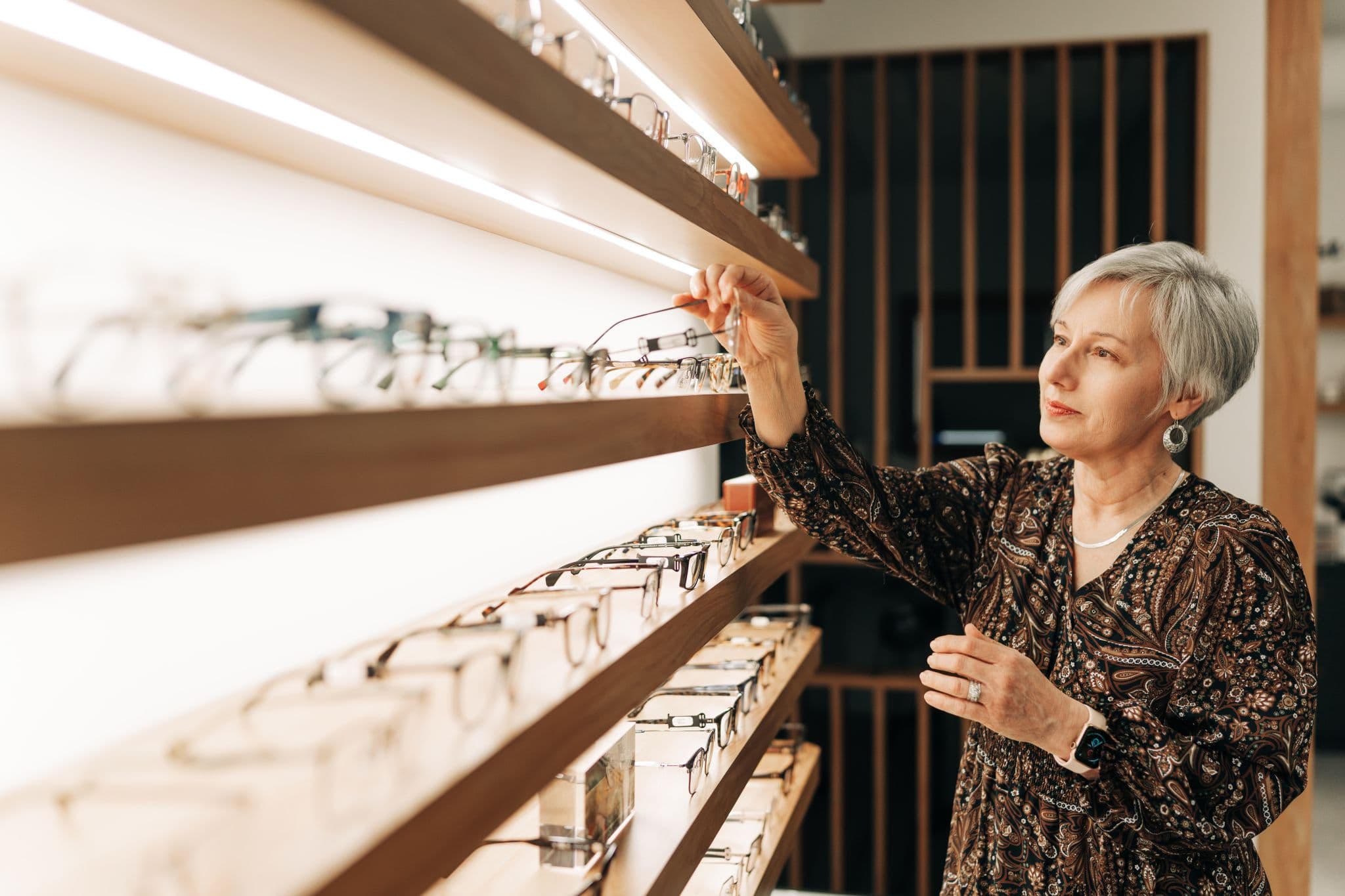 Customer browsing the frame collection along the dispensing wall