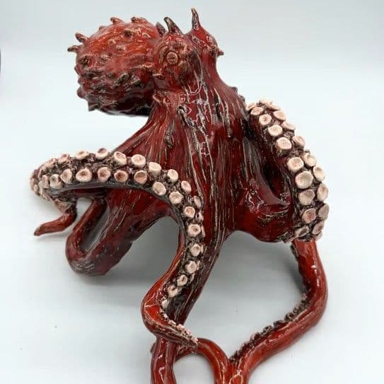 Sculpted red ceramic octopus with intricate tentacles