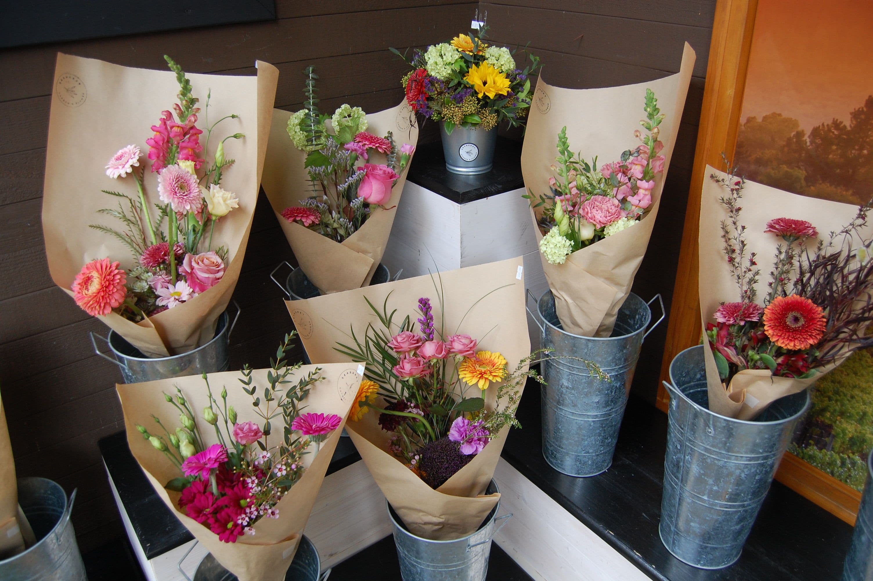 Fresh tulips and a floral arrangement in a galvanised pail