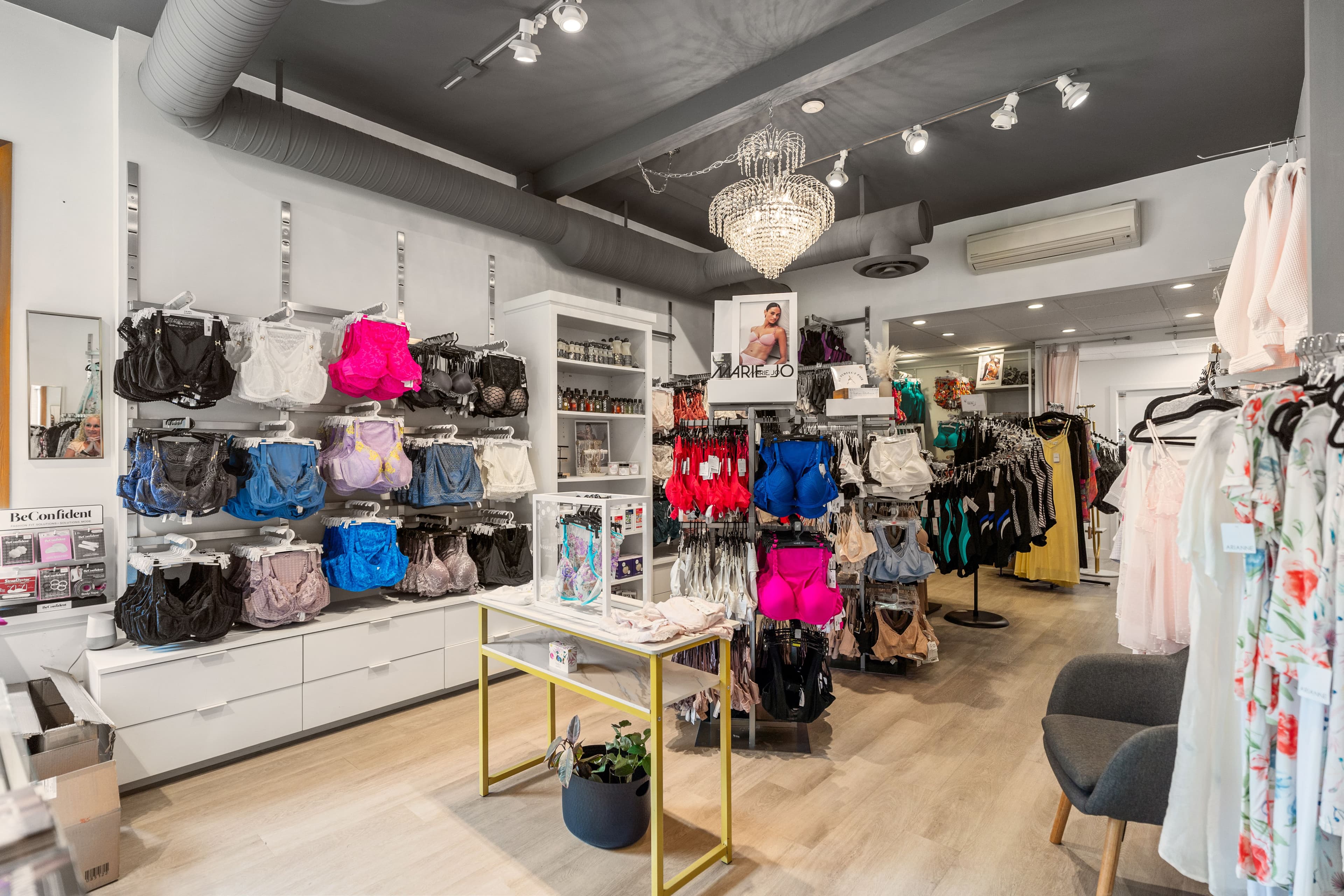 Lily Pad Lingerie interior with chandelier, handbags wall and bra displays
