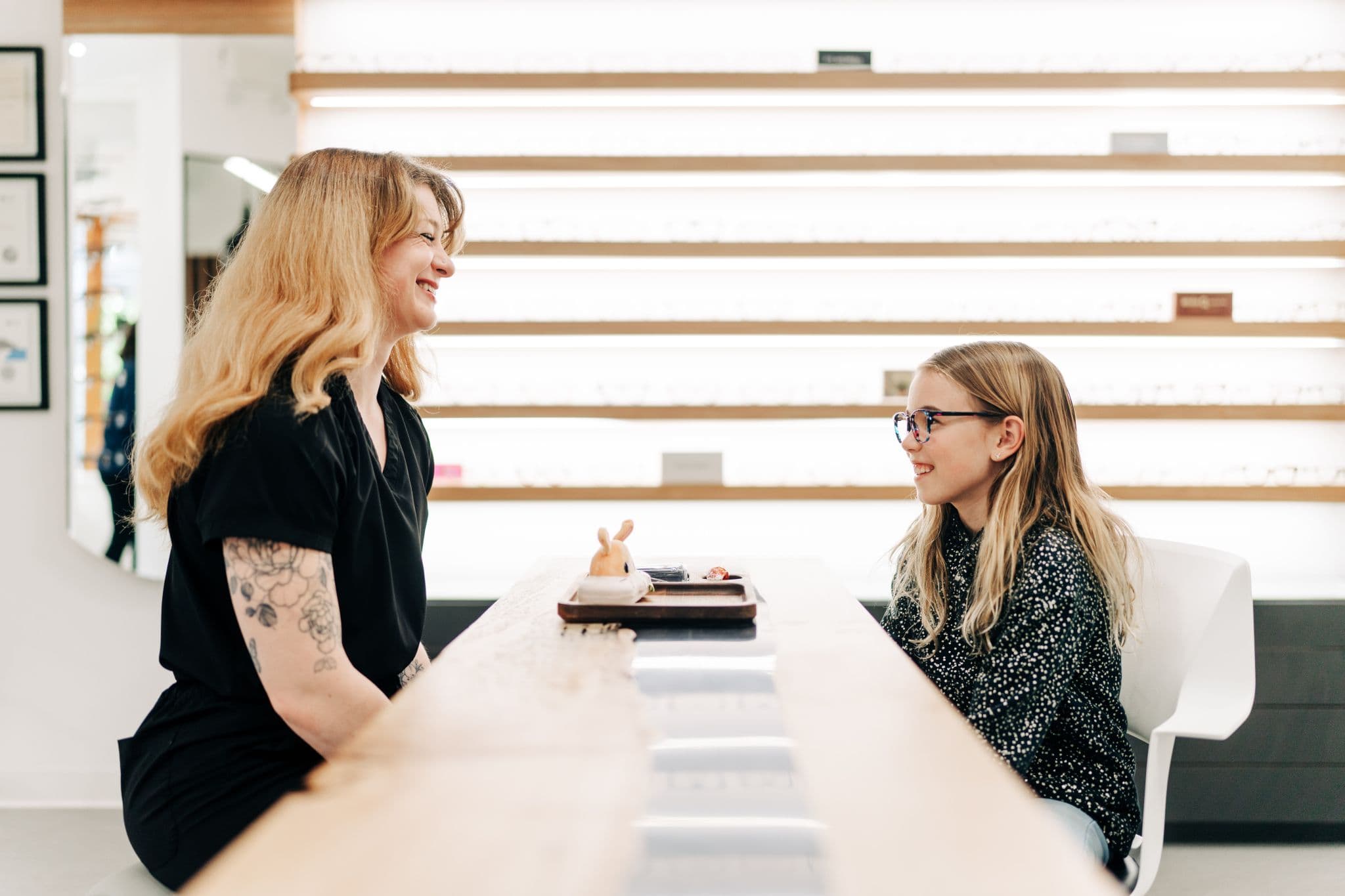 Staff member helping a young customer at the dispensing counter