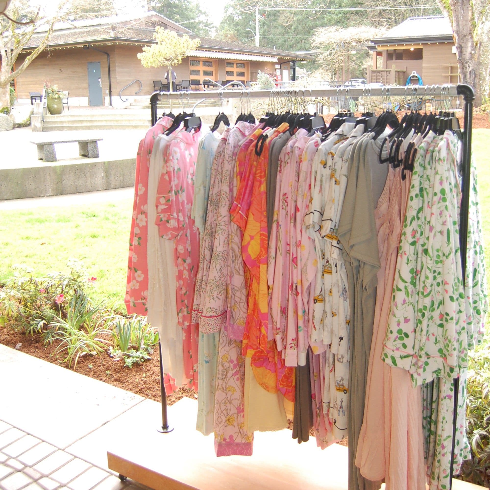 Outdoor garment rack with floral kimonos in front of the shop