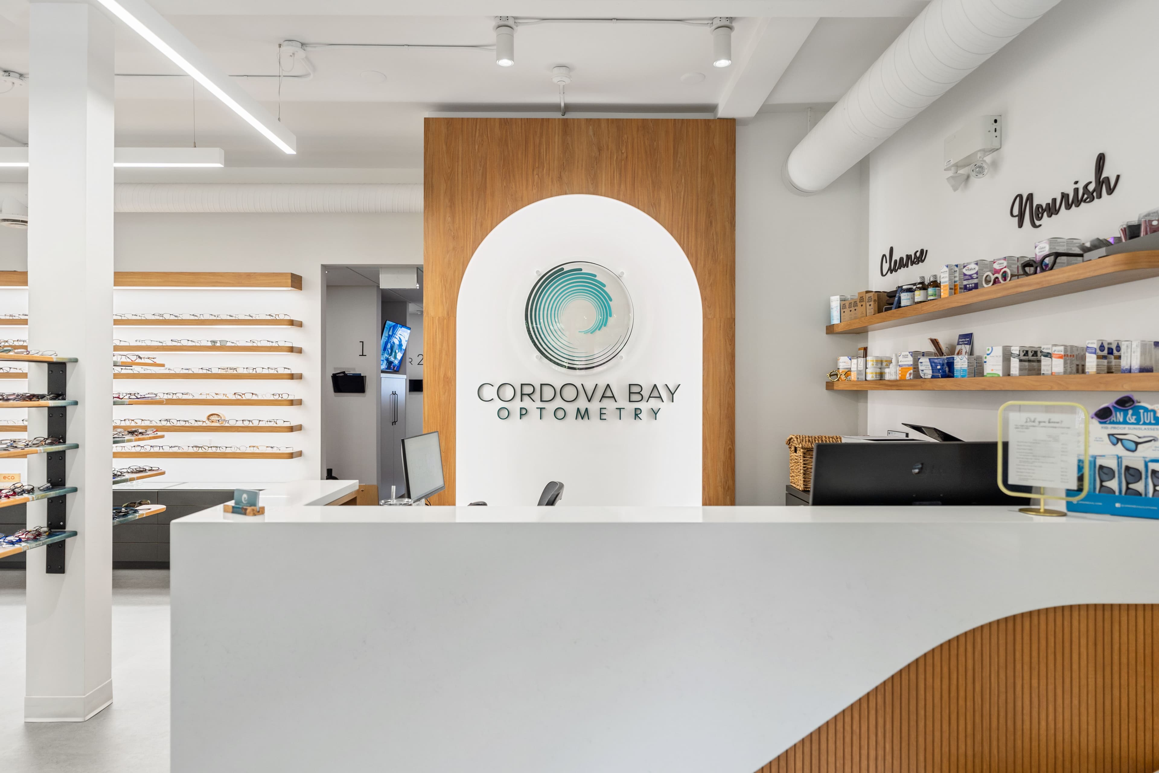 Reception desk close-up with branded arch and wordmark