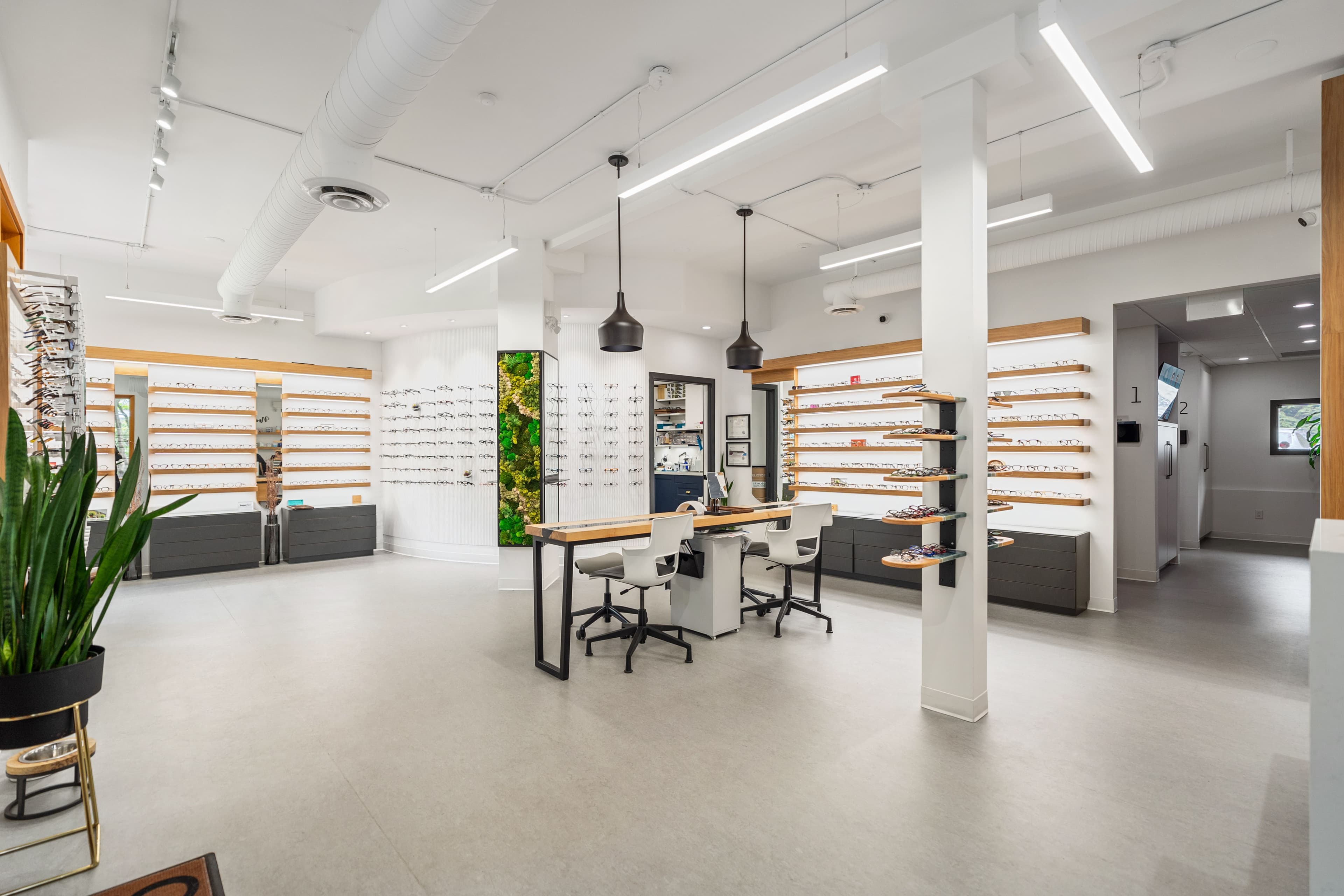 Wide view of the dispensing area with desks and frame walls