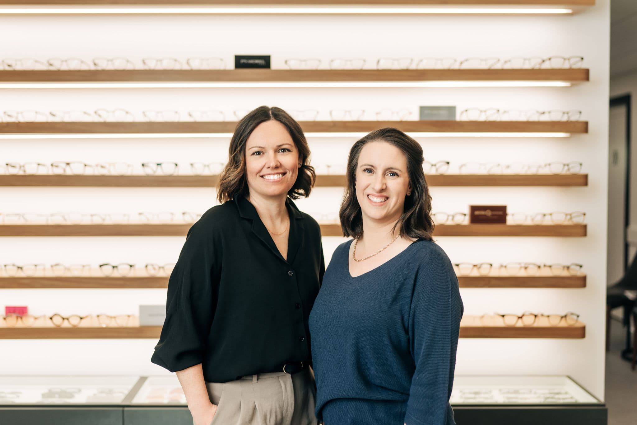 Drs. Meister and Goddard in front of the frame wall